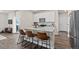 Modern kitchen featuring an island with bar seating, stainless steel appliances, and white cabinetry at 5297 Blue Lunar Ln, Castle Rock, CO 80104