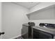 A modern laundry room with gray front-load washer and dryer, offering convenience and efficiency at 5297 Blue Lunar Ln, Castle Rock, CO 80104