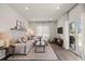 Bright living room with modern decor, hardwood floors, and large windows for natural light at 5297 Blue Lunar Ln, Castle Rock, CO 80104