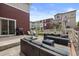 Back patio with comfortable seating, gas grill and views of the well-maintained, fenced backyard at 5297 Blue Lunar Ln, Castle Rock, CO 80104