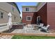 Rear patio with seating and outdoor grill, open to artificial turf and rock landscaping at 5297 Blue Lunar Ln, Castle Rock, CO 80104