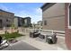 Rear patio with comfortable seating, fire pit, and views of the grassy, fenced backyard at 5297 Blue Lunar Ln, Castle Rock, CO 80104
