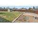 Large backyard with a shed, wooden fence, grassy lawn, and garden bed at 1207 S Memphis St, Aurora, CO 80017