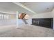Unfinished basement has carpet, a brick fireplace, and stairs at 1207 S Memphis St, Aurora, CO 80017