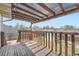 Enjoy outdoor living on this covered deck with wood railing overlooking the backyard at 1207 S Memphis St, Aurora, CO 80017