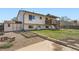 View of home's back exterior showing deck, backyard, storage shed, and garden at 1207 S Memphis St, Aurora, CO 80017
