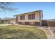 Charming two-story home with an attached garage, tidy lawn and brick accents at 1207 S Memphis St, Aurora, CO 80017