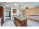 Kitchen with a granite countertop island, stainless steel sink, and tiled floors at 1207 S Memphis St, Aurora, CO 80017