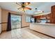 Bright eat-in kitchen features a ceiling fan, granite countertops, and sliding glass doors to the deck at 1207 S Memphis St, Aurora, CO 80017