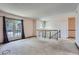 Bright living room with carpeting, a large window and an open staircase to the lower level at 1207 S Memphis St, Aurora, CO 80017