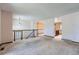 Open-concept living room featuring stairs, access to the kitchen, and lots of natural light at 1207 S Memphis St, Aurora, CO 80017