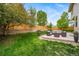 Lush backyard with a spacious patio and privacy fence at 4850 Bluegate Ln, Highlands Ranch, CO 80130