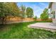 The large backyard is enhanced with a stone retaining wall and a privacy fence, offering a serene outdoor space at 4850 Bluegate Ln, Highlands Ranch, CO 80130