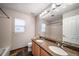 Bathroom featuring double sinks with granite countertops and tile flooring, providing a functional and elegant space at 4850 Bluegate Ln, Highlands Ranch, CO 80130
