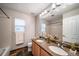 Bathroom offering double sinks, granite counters, tiled flooring, and ample natural light at 4850 Bluegate Ln, Highlands Ranch, CO 80130
