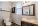 Cozy half-bathroom features a dark cabinet sink and light colored granite countertop at 4850 Bluegate Ln, Highlands Ranch, CO 80130