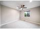 Bedroom with plush carpet, a ceiling fan, and a large window at 4850 Bluegate Ln, Highlands Ranch, CO 80130