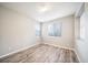 Bright bedroom with gray wood flooring and windows with white shutters at 4850 Bluegate Ln, Highlands Ranch, CO 80130