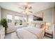Bedroom bathed in natural light features a ceiling fan, neutral walls, and contemporary decor at 4850 Bluegate Ln, Highlands Ranch, CO 80130