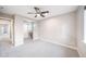 Spacious bedroom with a window, ceiling fan, and adjacent study nook at 4850 Bluegate Ln, Highlands Ranch, CO 80130