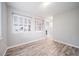 Bedroom with gray wood flooring and windows with white shutters at 4850 Bluegate Ln, Highlands Ranch, CO 80130