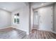 Entryway showing wood-look flooring and a white front door at 4850 Bluegate Ln, Highlands Ranch, CO 80130