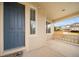 Covered porch shows a blue front door, beige siding, and manicured landscape at 4850 Bluegate Ln, Highlands Ranch, CO 80130