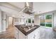 Kitchen island with stainless cooktop and range hood, plus a view to a spacious backyard at 4850 Bluegate Ln, Highlands Ranch, CO 80130