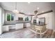 Open kitchen with white cabinets, stainless steel appliances, and an island with seating at 4850 Bluegate Ln, Highlands Ranch, CO 80130