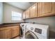 Laundry room equipped with modern washer and dryer, upper cabinets, and a countertop, perfect for efficient laundry management at 4850 Bluegate Ln, Highlands Ranch, CO 80130
