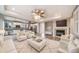 Inviting open floor plan with fireplace and light-colored decor at 4850 Bluegate Ln, Highlands Ranch, CO 80130