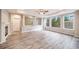 Spacious living room boasting natural light, wood-look flooring, and a fireplace at 4850 Bluegate Ln, Highlands Ranch, CO 80130