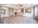 Spacious living room features gray flooring, a ceiling fan, and a cozy fireplace at 4850 Bluegate Ln, Highlands Ranch, CO 80130