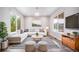 Bright living room featuring neutral décor, large windows, and comfortable seating at 4850 Bluegate Ln, Highlands Ranch, CO 80130