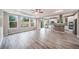 Living space with gray flooring, large windows, and open kitchen with stainless appliances at 4850 Bluegate Ln, Highlands Ranch, CO 80130