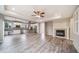 Open concept living space with gray flooring, fireplace, and kitchen with stainless appliances at 4850 Bluegate Ln, Highlands Ranch, CO 80130