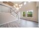 Bright, open living room features two-story ceiling, wood-look floors and staircase at 4850 Bluegate Ln, Highlands Ranch, CO 80130