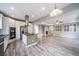 Spacious living room flows into a modern kitchen, with gray floors throughout at 4850 Bluegate Ln, Highlands Ranch, CO 80130