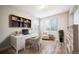 Bright office with built-in shelves, white desk, and wood-look floors at 4850 Bluegate Ln, Highlands Ranch, CO 80130