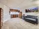 This carpeted basement has plenty of open space with a gray sofa and a large painting on the wall at 9931 E Ida Pl, Greenwood Village, CO 80111