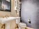 Chic bathroom with a pedestal sink, elegant fixtures, and modern decor at 9931 E Ida Pl, Greenwood Village, CO 80111