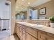 Upstairs bathroom with a large mirror, double sinks, and light wood cabinets at 9931 E Ida Pl, Greenwood Village, CO 80111