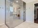 Modern bathroom showcasing a glass shower with gray tiling, a wooden shower chair, and chrome fixtures at 9931 E Ida Pl, Greenwood Village, CO 80111