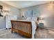 Inviting bedroom showcasing a dresser, decorative lamps, and a wood-frame bed at 9931 E Ida Pl, Greenwood Village, CO 80111