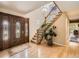 Bright foyer with hardwood floors, a staircase, and a decorative front door at 9931 E Ida Pl, Greenwood Village, CO 80111