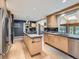 Spacious kitchen features a center island, modern stainless appliances, and hardwood floors at 9931 E Ida Pl, Greenwood Village, CO 80111
