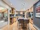 Spacious kitchen featuring stainless appliances, center island, and wood floors with breakfast nook at 9931 E Ida Pl, Greenwood Village, CO 80111