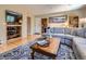 Inviting living room with wood floors, built-in shelves, and a comfortable sectional sofa at 9931 E Ida Pl, Greenwood Village, CO 80111