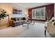 Comfortable living room featuring a large window, plush sofa, and stylish decor at 9931 E Ida Pl, Greenwood Village, CO 80111
