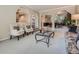Bright living room with neutral tones, plush carpet, and open archways to other rooms at 9931 E Ida Pl, Greenwood Village, CO 80111